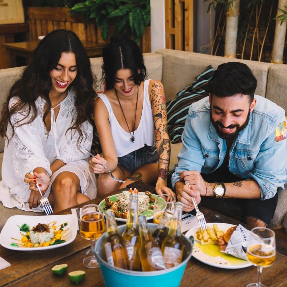 Diners laughing together over a shared meal